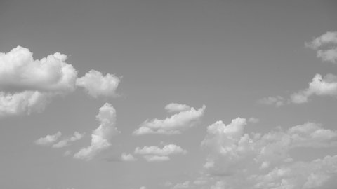 4k black and white timelapse of beautiful blue sky and white clouds flying. Abstract natural video background