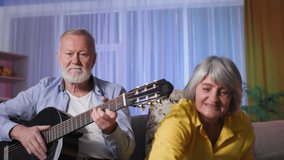 online guitar training for the elderly, gray-haired grandparents waving their hands in front of laptop webcam and playing at home