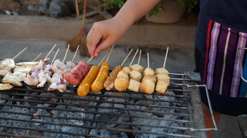 Barbecue meatball skewers cooking grilled street food thailand market.