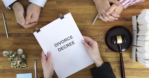 Judge submits documents with court decision on divorce to married couple for signature