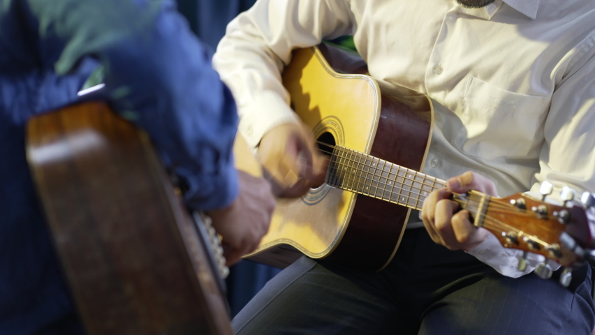 two musician playing guitar together on stage
