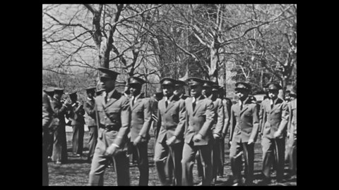 1940s: College campus. Young men march in uniform. Caption reads "THE RELIGIOUS LIFE CENTERS AROUND THE CAMPUS CHURCH." Church bell rings. Tower.