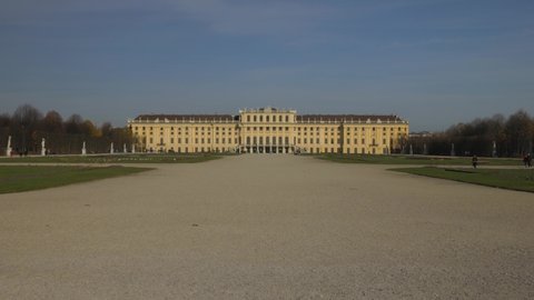 VIENNA AUSTRIA - NOV 12. 2019 Move in Shot of Schönbrunn Palace  Schonbrunn Palace, moving towards palace baroque garden of Schönbrunn Palace, blue sky, people walking along, no sound