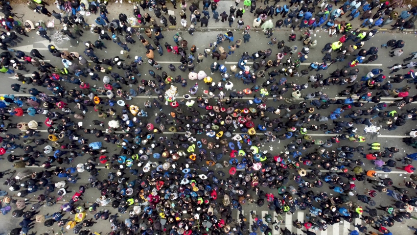 Aerial drone view of large group of people on the street. Crowd of people, view from above. Royalty-Free Stock Footage #1082911549