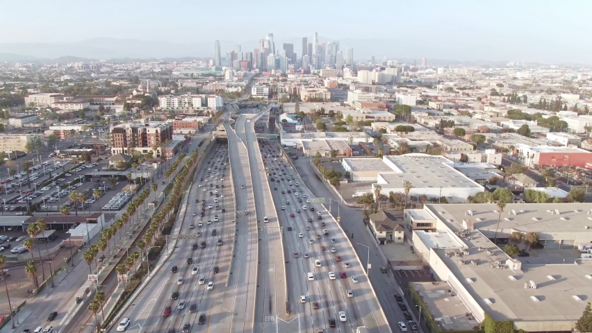 LOS ANGELES, CA, USA - Nov 5, 2021: Aerial view Los Angeles freeway, cars and trucks on road traffic on highway to downtown LA. urban modern city in USA, travel destination in America. Drone 4k. 
