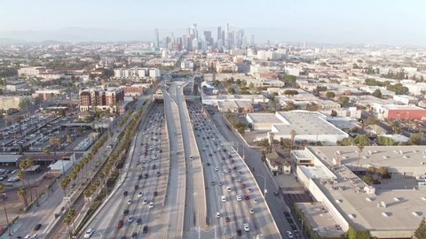 LOS ANGELES, CA, USA - Nov 5, 2021: Aerial view Los Angeles freeway, cars and trucks on road traffic on highway to downtown LA. urban modern city in USA, travel destination in America. Drone 4k. 
