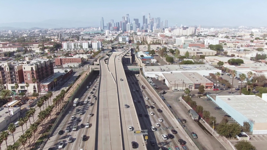 LOS ANGELES, CA, USA - Nov 5, 2021: Freeway to Los Angeles. Aerial view cars on highway road to downtown LA. urban commute in modern city in California, America. Drone 4k. 