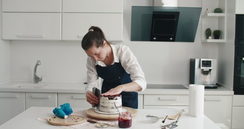 Woman making chocolate cake in kitchen, close-up. Cake making process, Selective focus. High quality 4k footage