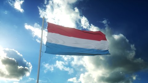 Flag of Luxembourg waving at wind against beautiful blue sky