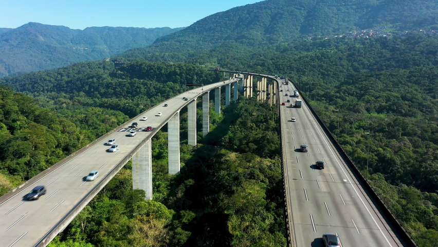 Aerial view of traffic at Immigrants highway road bridge between mountains. Santos, state of Sao Paulo, Brazil.