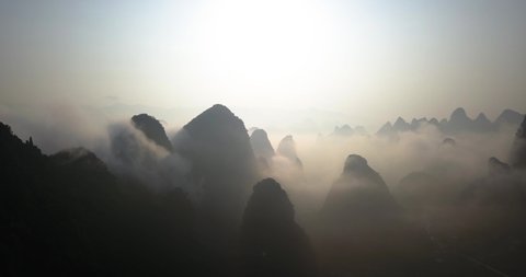 Karst Mountains Covered With Fog At Sunrise In Yangshuo,Guilin,China. - wide shot