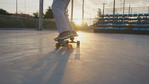 Asian women  playing surf skate on stadium in morning and sunlight, Medium long shot, Copy space, Concept of workout outdoor
