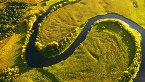 Top down view of a winding river in the wild area. Bird's eye view. Location place Horyn river, Ukraine, Europe. Cinematic aerial shot. Discover the beauty of earth. Filmed in 4k, drone video.