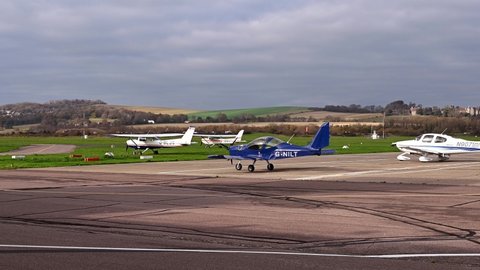Shoreham, West Sussex, UK, November 16, 2021. Evektor ev-97 and Cirrus SR-20 G-NILT visiting Brighton City Airport with Lancing College and the South Downs in the background.