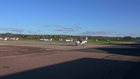 Shoreham, West Sussex, UK, November 21, 2021. Cessna 152 Aerobat G-BFRV taxiing at Brighton City Airport with Lancing College and the South Downs in the background.