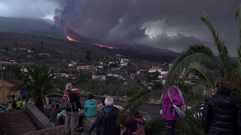 El Paso , La Palma , Spain - 10 24 2021: People stand watching the Cumbre Vieja volcanic eruption