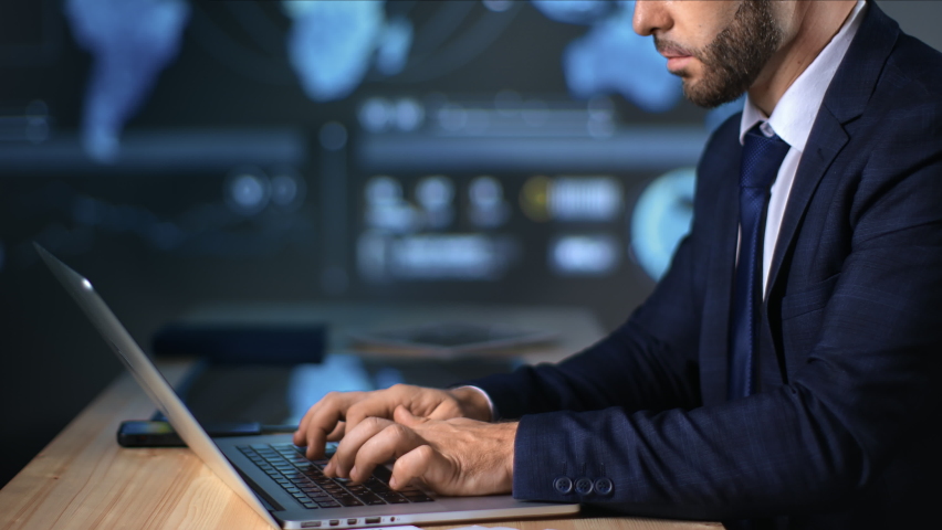 Closeup fashion business male in suit working use laptop at hi tech office infographics scheme diagram hologram screen. Confident successful boss financial trader online distance education elearning