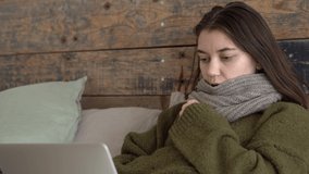 sick young female patient in sweater , medical consultation on videocall on laptop in telehealth, telemedicine. attractive woman coughing, sneezing. coronavirus, flu, 4k footage