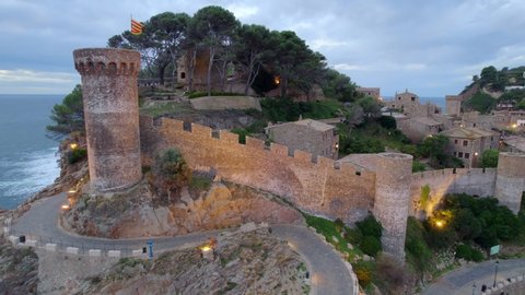 Aerial view of seaside town Tossa de Mar with medieval fortress on the coast on a stormy cloudy evening, Costa Brava, Spain