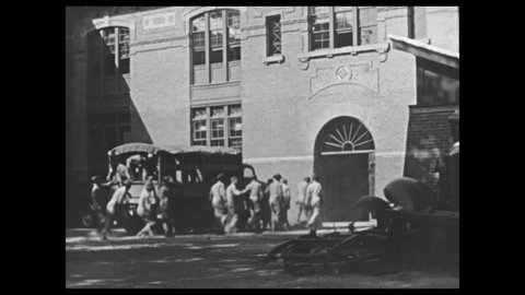 1940s: College campus. Men climb out of truck. Men walk away. Men work on military truck. Men work in machine shop. Caption reads "HAMPTON GRADUATES RANK HIGH IN EMPLOYMENT."
