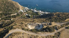 Aerial drone video of iconic ancient theatre of Milos island where statue Venus of Milo was discovered, Cyclades, Greece