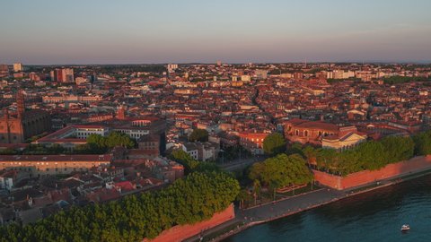 Establishing Aerial View Shot of Toulouse Fr, Haute-Garonne, France, sunest over riverside and Basilica of Our Lady of the Daurade
