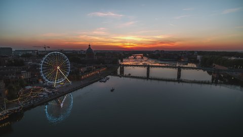 Establishing Aerial View Shot of Toulouse Fr, Haute-Garonne, France, sunset, evening, river Garonne and ferris wheel 