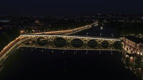 Establishing Aerial View Shot of Toulouse Fr, Haute-Garonne, France at night evening, bridge Neuf, calm city
