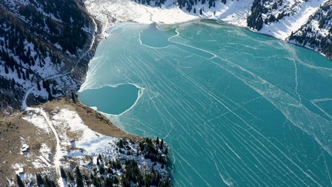 Aerial flight over Big Almaty Lake in winter. Kazakhsan