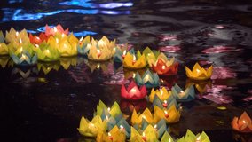 Floating colored lanterns and garlands on river at night on Vesak day in Saigon River for celebrating Buddha's birthday, that made from paper and candle. Commemorating those who have passed away - Powered by Shutterstock - Get 15% off with code: PIKWIZARD15