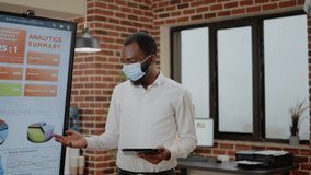 Business people doing teamwork for project planning and presentation. Colleagues with face mask working on startup development and marketing strategy with monitor during pandemic. - Powered by Shutterstock - Get 15% off with code: PIKWIZARD15
