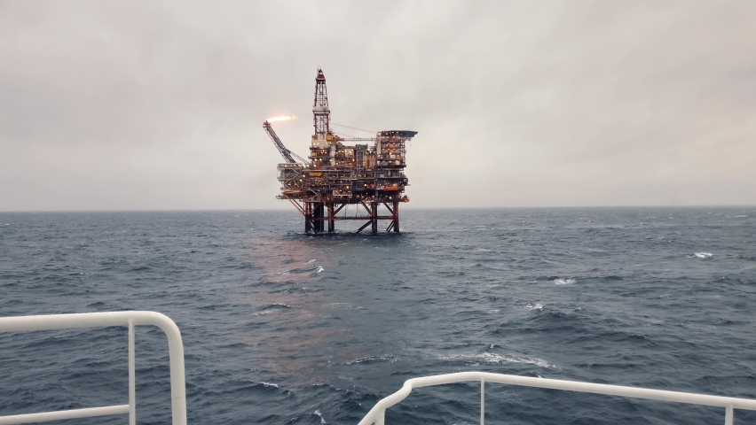 Offshore oil and gas industry. Oil platform or rig in north sea | Shutterstock HD Video #1082985856