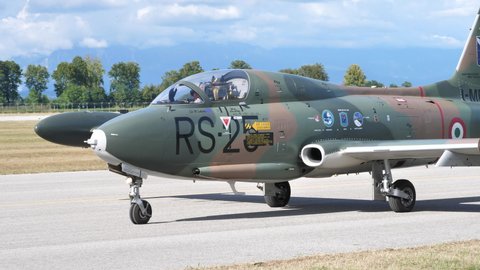Rivolto Italy SEPTEMBER, 17, 2021 Cold War ground attack military jet plane with camouflage of an unknown African air force rolls on the runway. Aermacchi or Macchi MB-326K I-MBCK by Volafenice