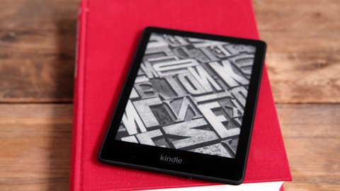 modern black e-book reader, digital book Kindle, tablet computer device for displaying text electronically on paper books, electronic paper technology, concept of reading fiction, text editing