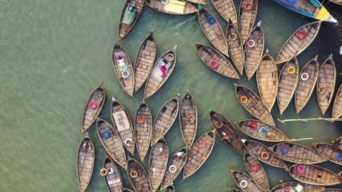Dhaka, Bangladesh - 26 September 2021: Aerial view of a fishing boats docked at Telghat boat terminal along Buriganga river in Keraniganj, Dhaka province, Bangladesh.