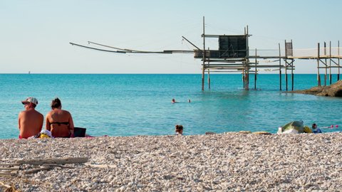 Vasto, Abruzzo - Jul 2021: Trabocco and beach of Punta Aderci. Trabucco a sort of Trebuchet, traditional wooden fishing house in southern Italy, on Costa dei Trabocchi (Coast Of the Trabocchi). RAW