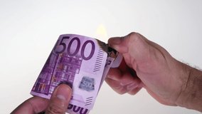 Burn Euro devaluation: heating gas cost concept. Out of Euro zone concept: 500 euro banknote burned by a lighter of a rich man.  Devaluation. concept of burning money, burning Euro, money in smoke - Powered by Shutterstock - Get 15% off with code: PIKWIZARD15