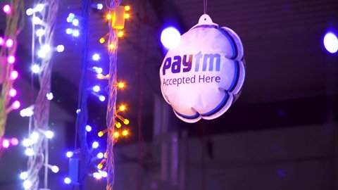 Noida, Delhi, India - circa 2021 : diwali string lights of various colors along with a Paytm dangler showing the successful IPO and celebrations for the Indian Unicorn digital payments provider