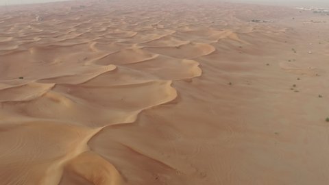 Aerial view of the desert in the UAE. Sand dunes in a beautiful landscape with desert nature on the Arabian Peninsula.
