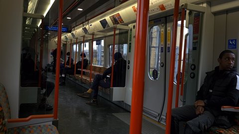 London. UK- 11.26.2021: passengers  in the carriage of a London Overground train.