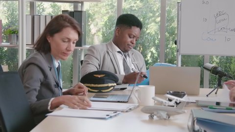 Airline business air hostess and captain aviator in uniform meeting discussion on flight business and training service of stewardess to understand yearly income and promotion
