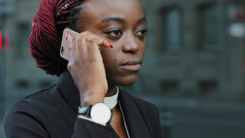 Portrait angry upset agressive powerful african american business woman female leader boss girl talking on phone negative call answering problem stress remote conversation negotiation walking in city | Shutterstock HD Video #1083048619