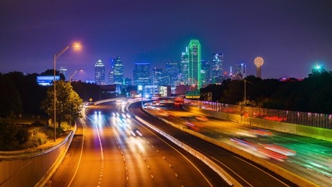 Dallas, Texas, USA downtown skyline and highway at dawn.