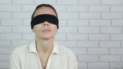 Blindfolded feminist. A blindfolded woman points her finger.