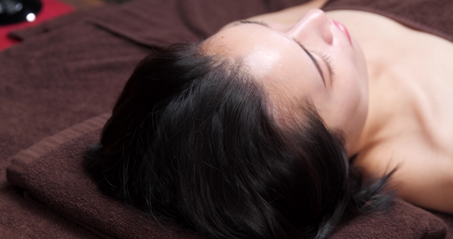 The woman is receiving a head massage. Royalty-Free Stock Footage #1083069295