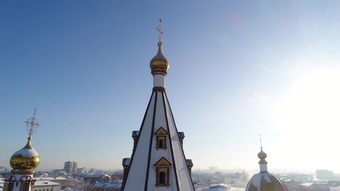 Russia, Irkutsk - January 20, 2021; Cathedral of the Epiphany of the Blessed Virgin in Irkutsk. Aerial drone flight. In winter, the Russian city is covered with ice and snow.