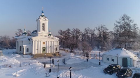 Russia, Irkutsk - January 20, 2021; Entry-Jerusalem Church in Irkutsk. Aerial drone flight. In winter, the Russian city is covered with ice and snow.