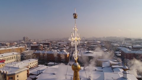 Russia, Irkutsk - January 20, 2021; Cathedral of the Epiphany of the Blessed Virgin in Irkutsk. Aerial drone flight. In winter, the Russian city is covered with ice and snow.