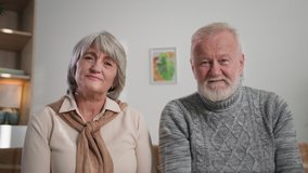 senior aged couple using laptop computer, smiling grandparents nod their heads together and waving hands on camera - Powered by Shutterstock - Get 15% off with code: PIKWIZARD15