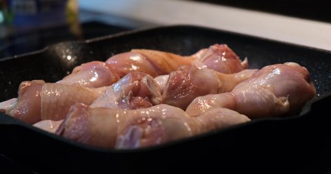 Chicken legs are fried in a grill pan. Chicken dish. The concept of recipes, home cooking, farm and store products. Junk food